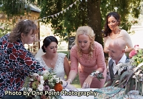 Picture of celebrant indicating where witness is to sign paperwork