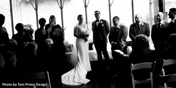 Picture from a wedding - celebrant reading, bride and groom in centre